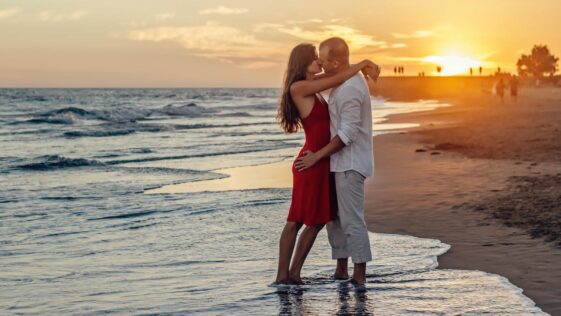 Couple Kissing on Beach during Golden Hour