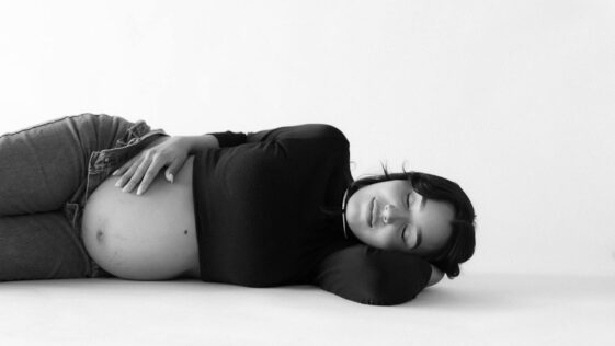 Pregnant Woman Lying Down with Eyes Closed