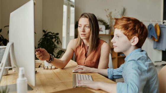 Photo Of Woman Tutoring Young Boy