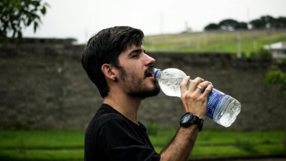 Man Wearing Black Shirt Drinking Water