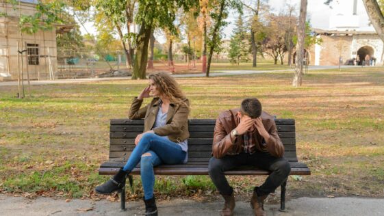Woman And Man Sitting on Brown Wooden Bench