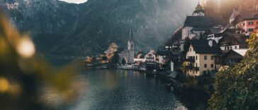 town beside body of water and mountains
