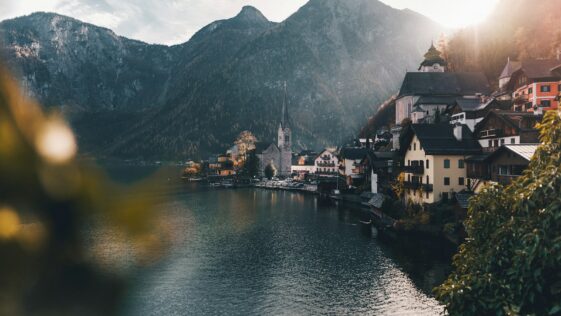 town beside body of water and mountains