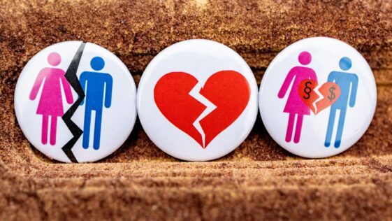 three buttons depicting a broken heart, a man and a woman