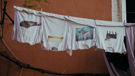 several white shirts hand on clothes wire