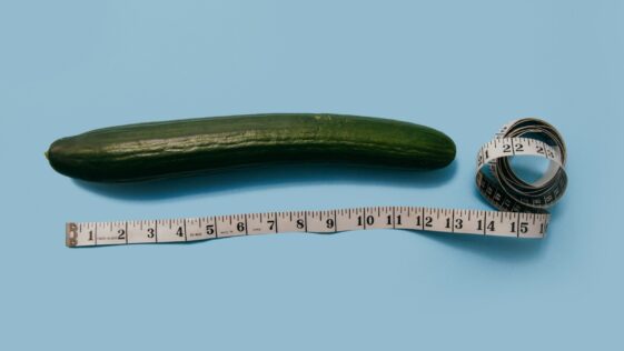 gourd and white tape measure on blue surface