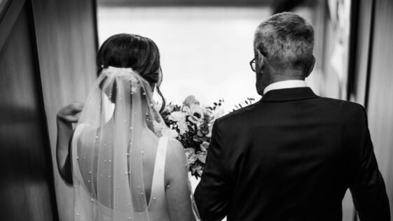 a man and a woman walking down a hallway