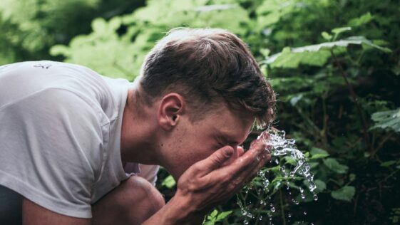 man washing his face