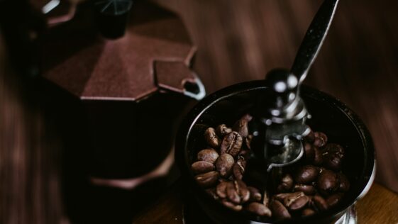 coffee beans in black ceramic mug