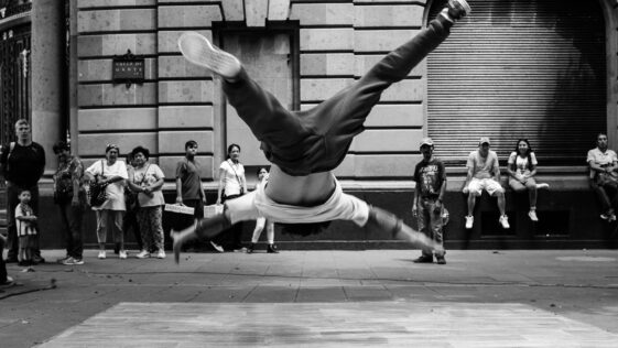 jumping man in grayscale photography