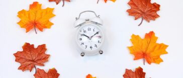 silver and white analog alarm clock