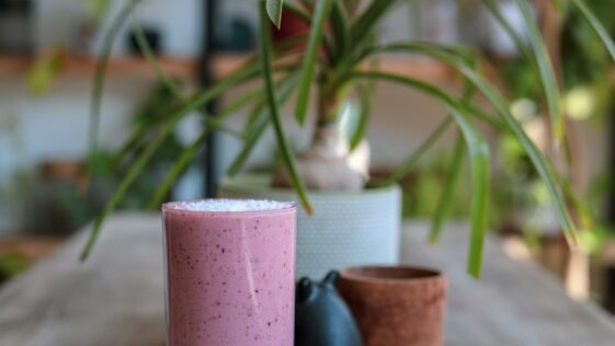 pink pillar candle on brown clay pot