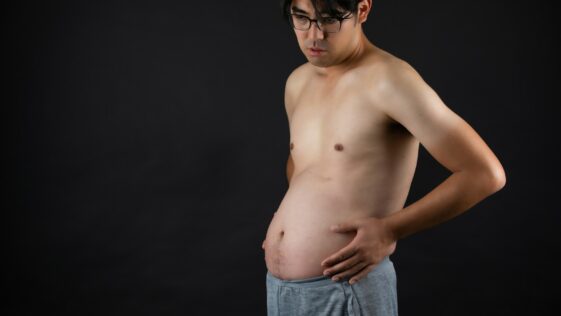 topless man in blue denim jeans