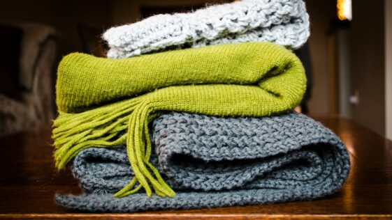 three gray, green, and white scarf on top of table