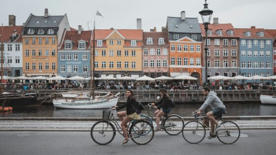 three people riding bicycles
