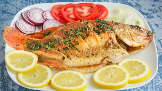 a plate of fish and lemons