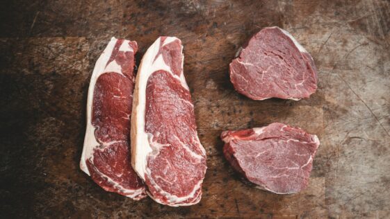 raw meat on brown wooden table