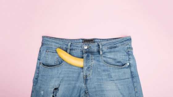 blue denim jeans on white textile