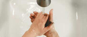 persons feet on white bathtub
