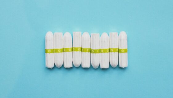 white oval medication pill on teal surface