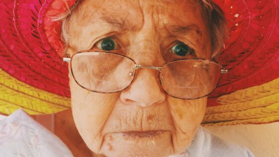 woman in white top wearing eyeglasses