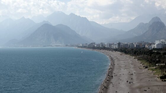 a view of a beach with mountains in the background