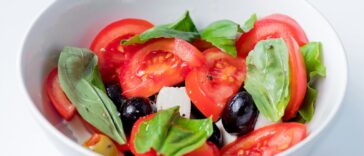 red and green bell pepper on white ceramic bowl