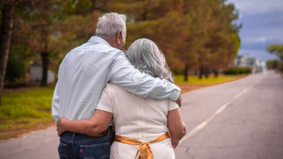 couple kissing on the road during daytime