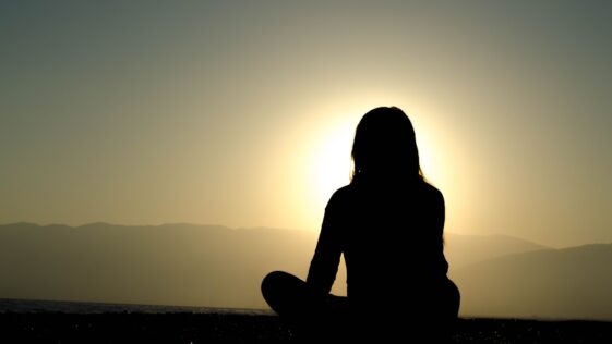 woman sitting on sand