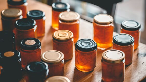 a table topped with lots of jars filled with liquid