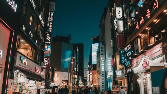 people walking between tall buildings