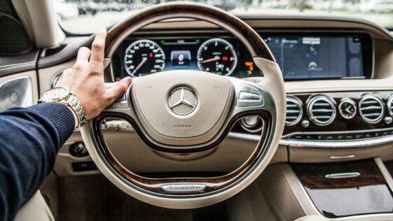 person sitting in Mercedes-Benz driver seat