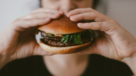 person holding burger