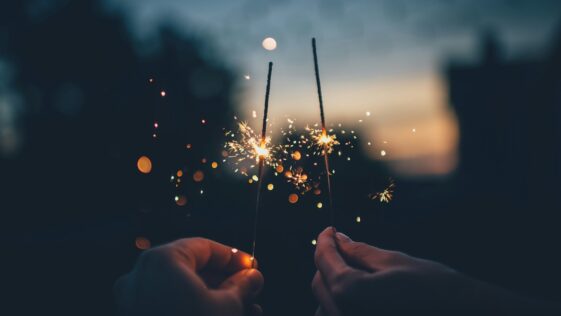 person holding fire cracker shallow focus photography