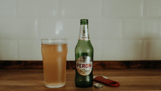 a bottle and a glass of beer on a table
