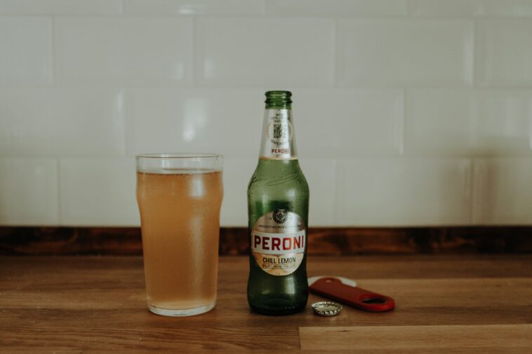 a bottle and a glass of beer on a table