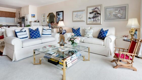 Modern living room with stylish decor and comfortable white sofas.