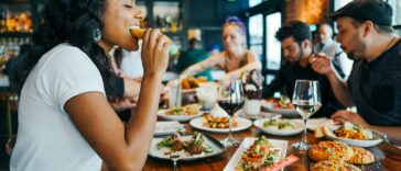 woman in white shirt eating