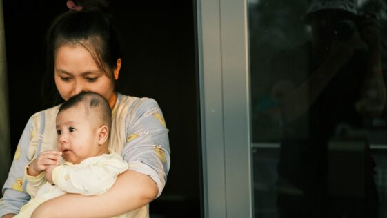 a woman holding a baby in her arms