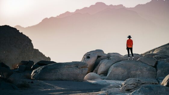 a person standing on top of a large rock