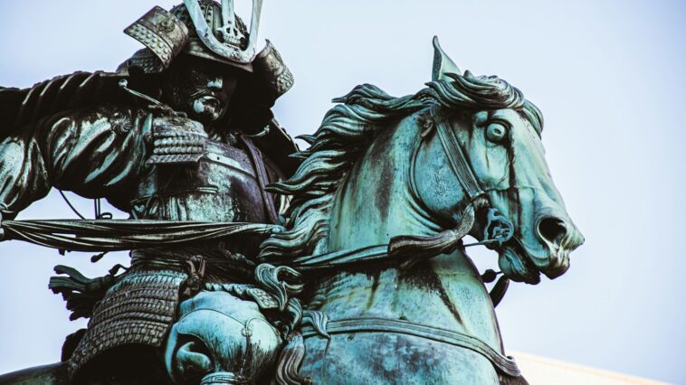 man riding horse statue during daytime