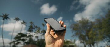 person holding black iPhone during daytime