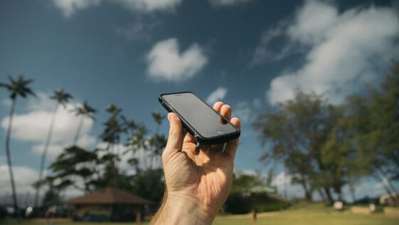 person holding black iPhone during daytime