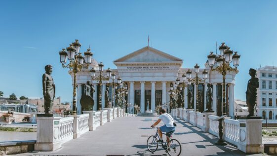 man on bike near building