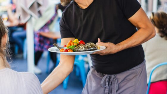 man standing and holding plate