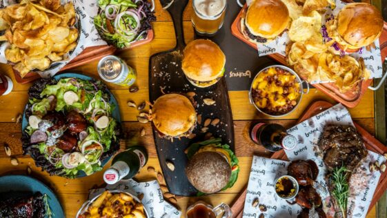 a wooden table topped with lots of food