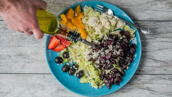 flat lay photography of man making vegetable and fruit salad