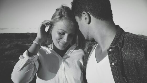 grayscale photography of man and woman