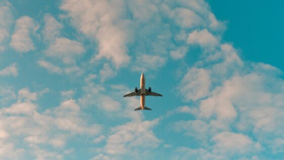 white airplane flying in the sky during daytime