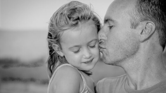 boy kissing her daughter